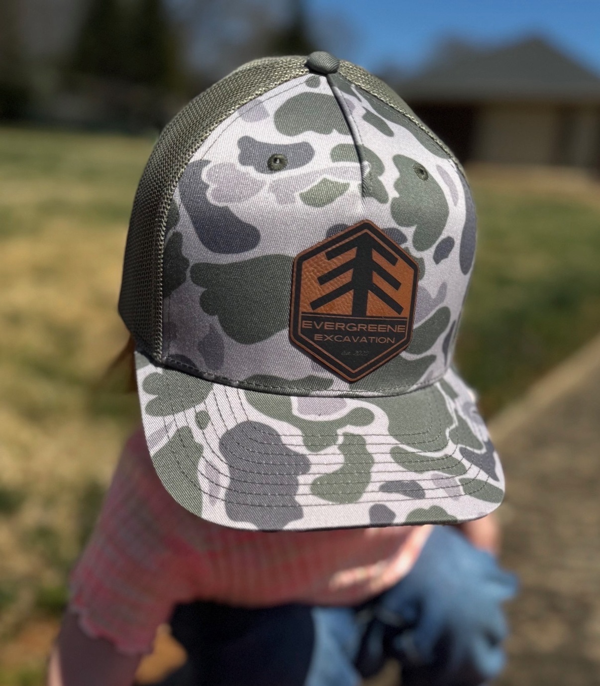 Evergreene Excavation bark camo trucker hat with leatherette hex patch, front view